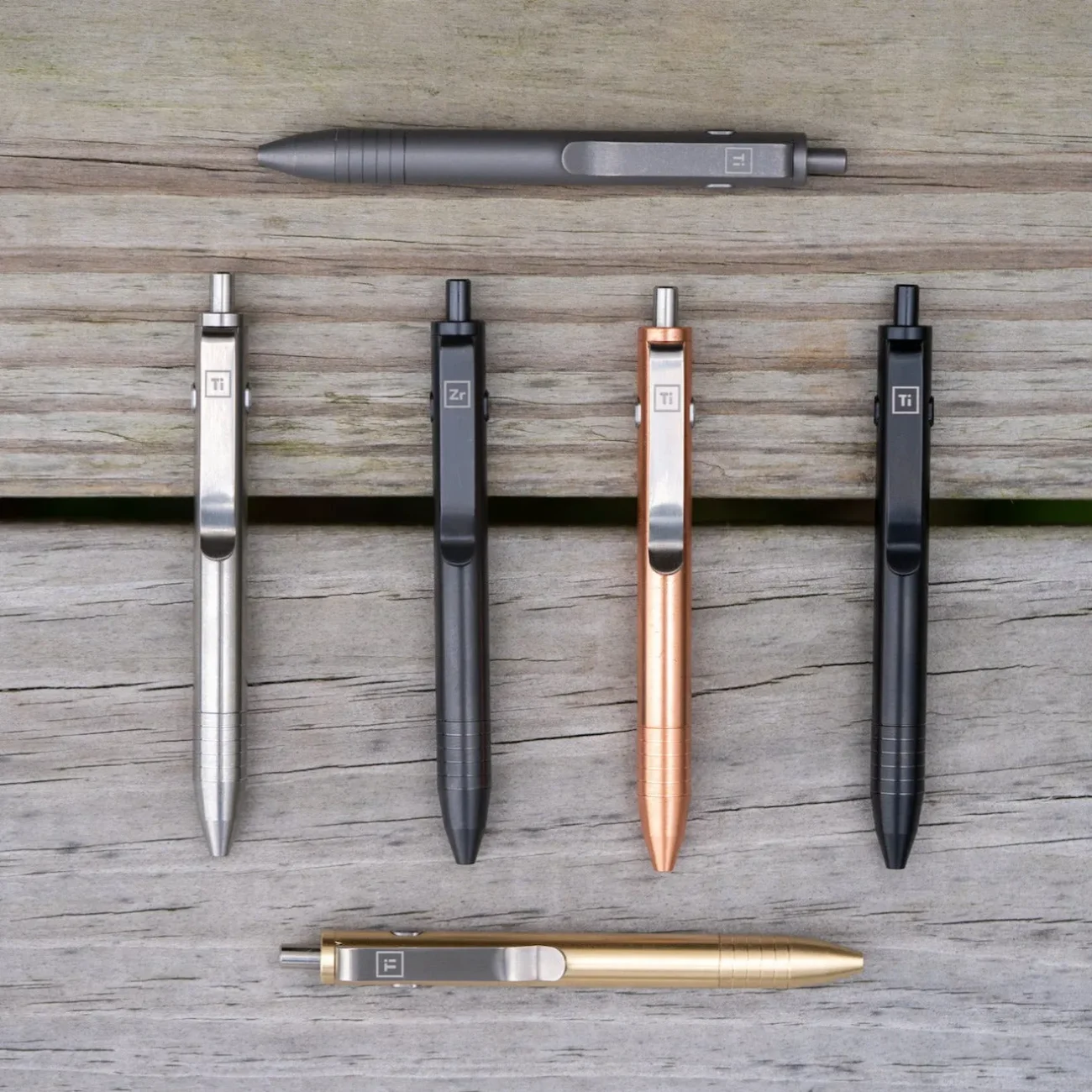 vendor-edc-pen-titanium-multi-color-metal-pens-wood-background